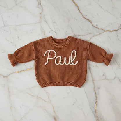 Sweater laid flat on marble