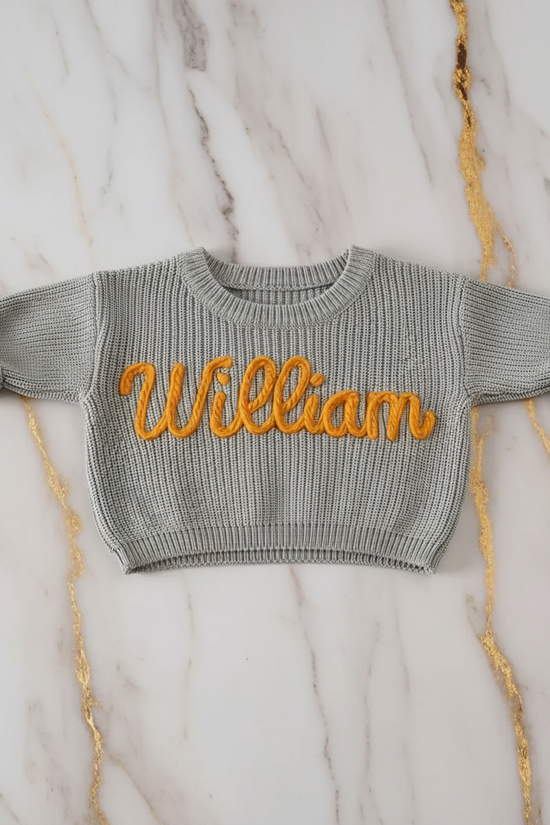 Sweater laid flat on marble