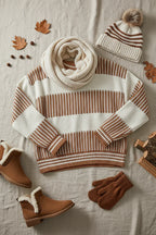 Sweater surrounded by winter accessories