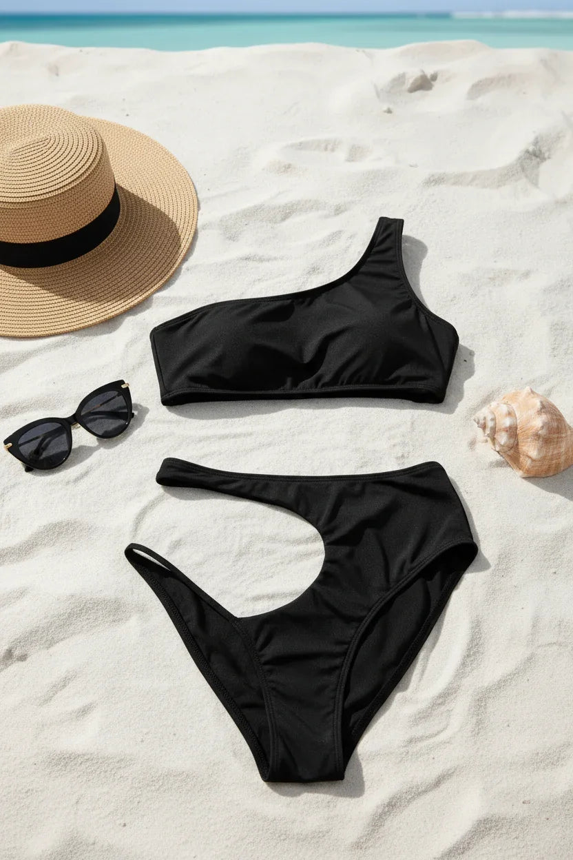 Swimsuit with beach accessories on sand
