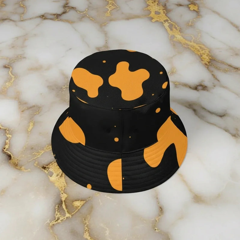 Black and yellow bucket hat with abstract pattern on marble surface, Ivorynn fashion accessory