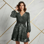 Woman in dark floral long-sleeve dress posing against modern marble wall, Ivorynn fashion