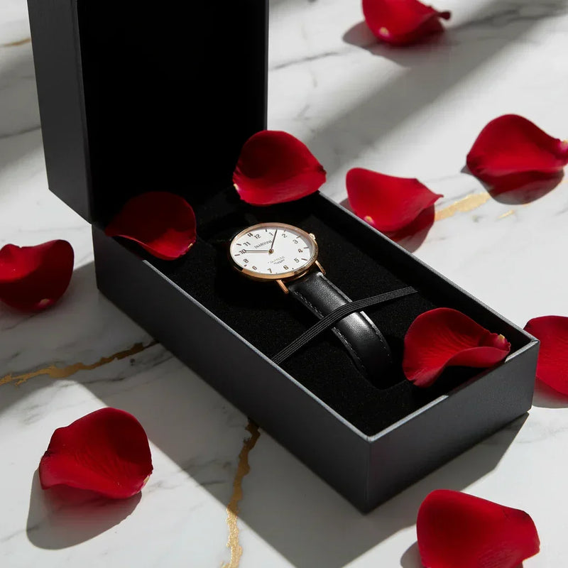 Watch close-up with rose petals