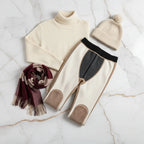 Winter outfit flat lay with turtleneck, scarf, and hat