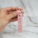 Woman holding keychain - close-up detail