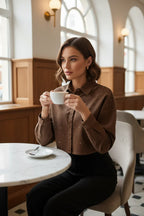 Woman in brown denim shirt with black trousers at café