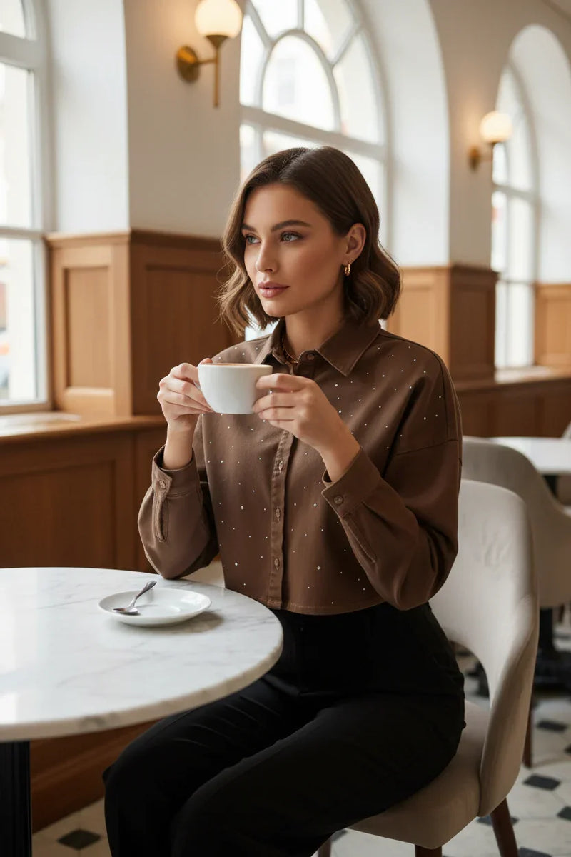 Woman in brown denim shirt with black trousers at café