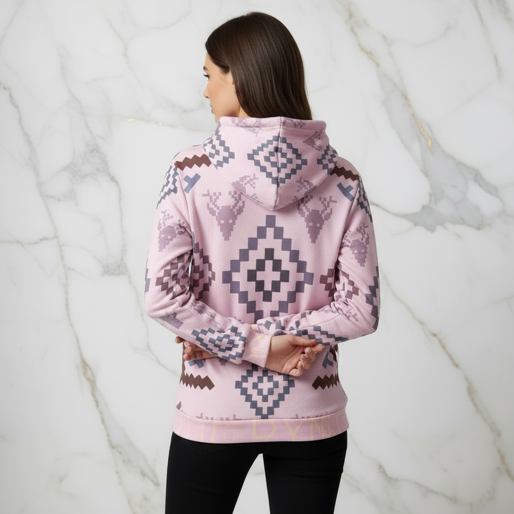 Woman in pink geometric hoodie - back with arms crossed