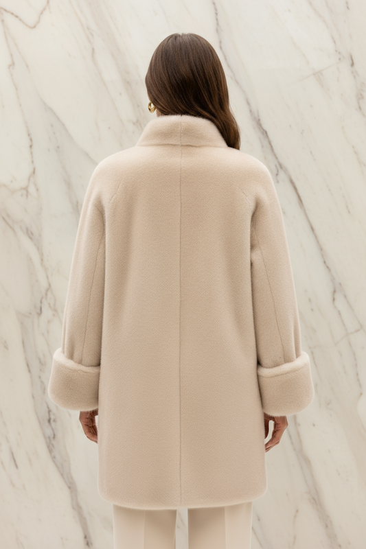 Woman wearing cream faux fur jacket - back view