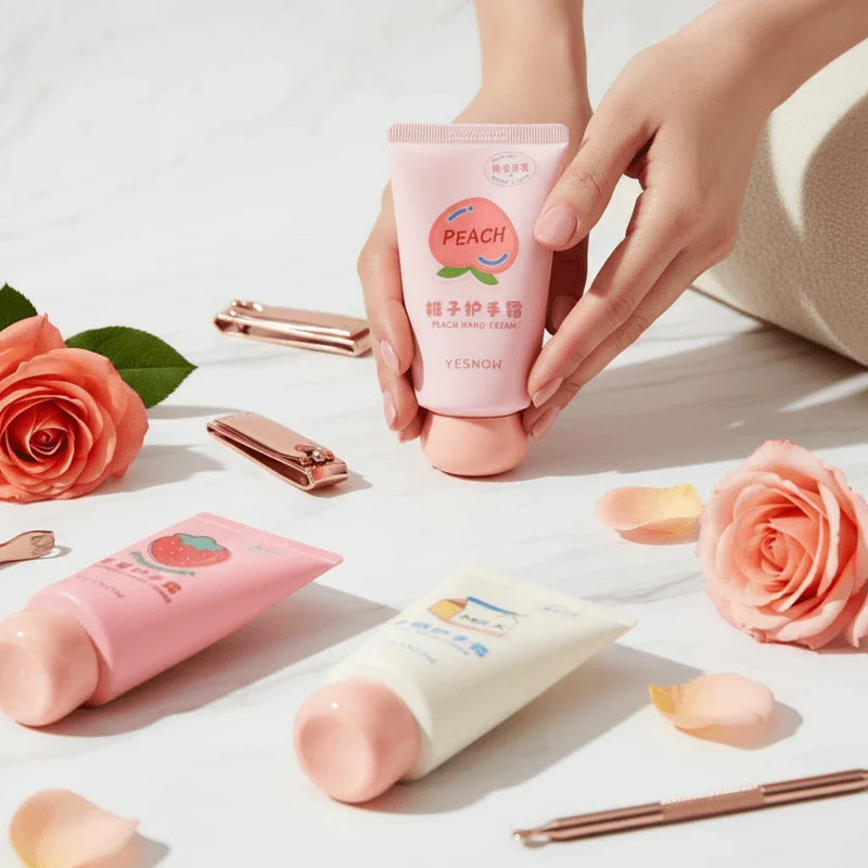 Fruit Fragrance Milky Hand Cream and peach hand creams surrounded by roses on a marble surface.