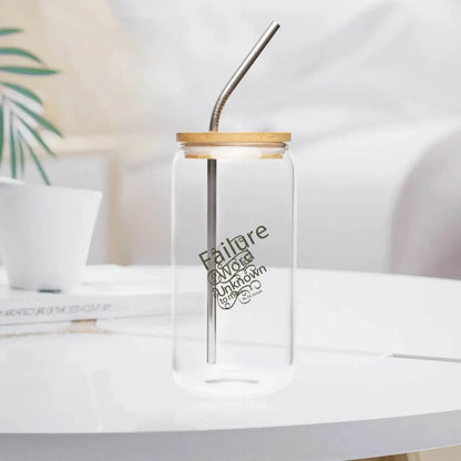 Clear glass with bamboo lid and metal straw on white table, modern kitchen decor.