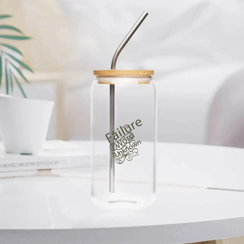 Clear glass with bamboo lid and metal straw on white table, modern kitchen decor.