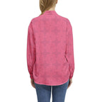 Woman wearing a pink floral long-sleeve button-up casual shirt from Ivorynn
