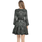 Woman wearing IVORYNN dark green long ruffle sleeve dress with elastic waist and white pattern