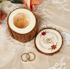 Personalized wooden ring box with engraved names, wedding date, and floral accents on lace, featuring two rings