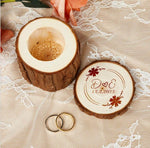 Personalized wooden ring box with engraved names, wedding date, and floral accents on lace, featuring two rings