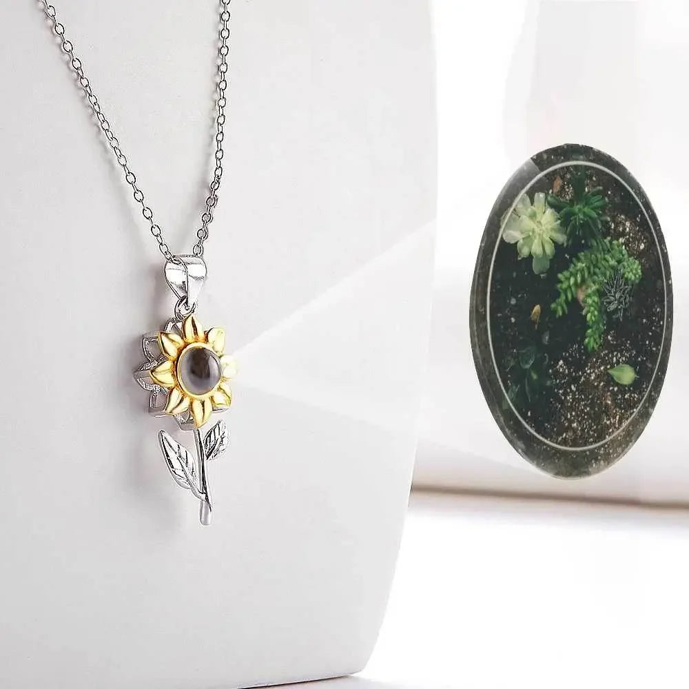 Silver sunflower pendant necklace with nano projection feature on a white background, Ivorynn jewelry.