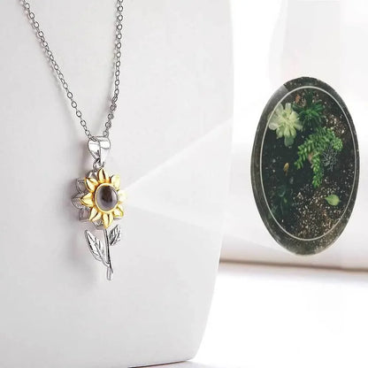 Silver sunflower pendant necklace with nano projection feature on a white background, Ivorynn jewelry.
