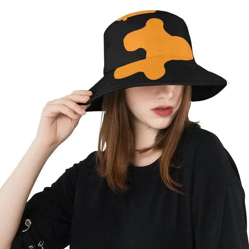 Woman wearing black bucket hat with bold orange pattern, trendy women's fashion at IVORYNN