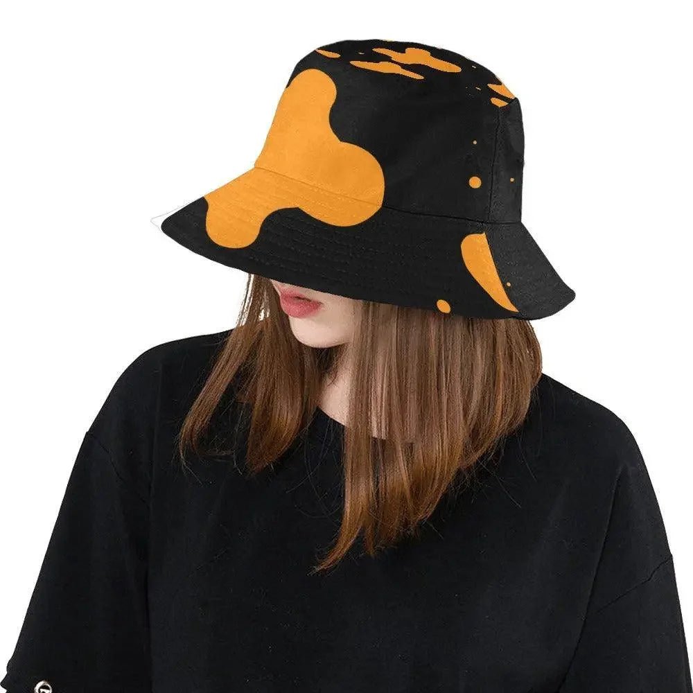 Woman in black shirt wearing ivorynn orange splatter print black bucket hat