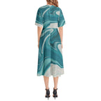 Woman wearing teal and white marble print midi dress with short sleeves, back view