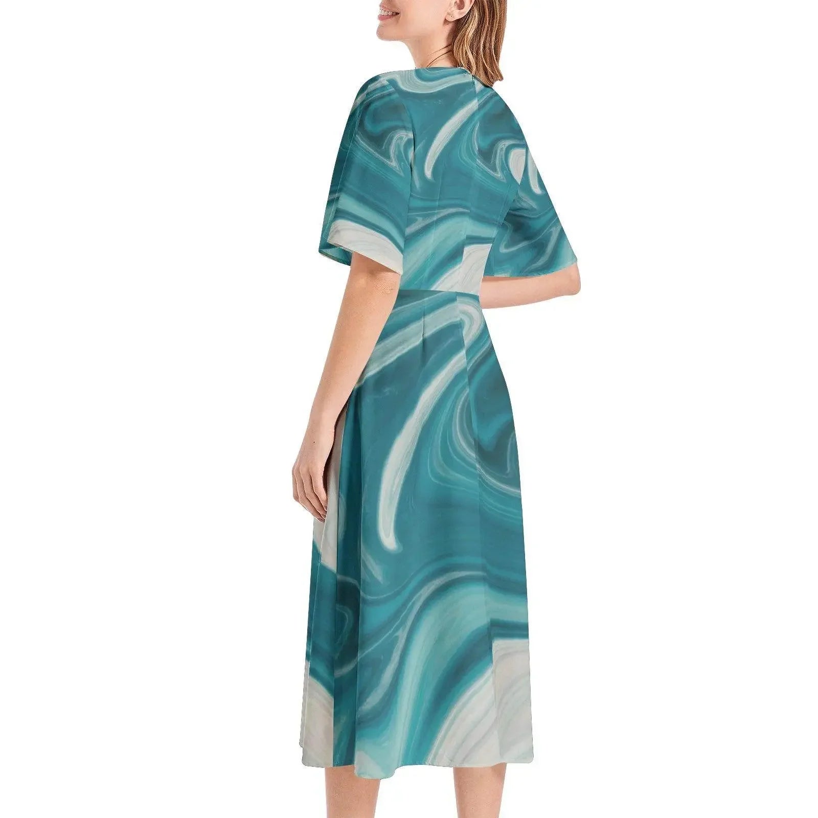 Woman wearing a teal marble-print short sleeve midi dress, modern fashion by IVORYNN