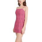 Woman modeling pink sleeveless spaghetti strap mini dress with subtle floral pattern from IVORYNN